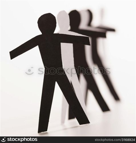 Black and white cutout paper people standing in line together.