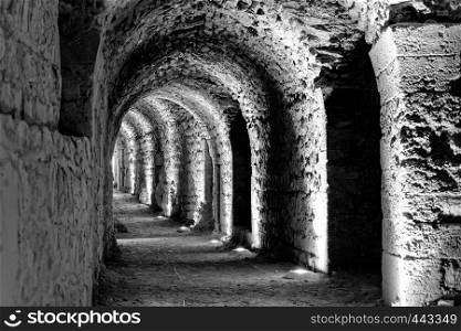 Black and white developed photo of the interior of the castle Karak with electric lights attached for the tourists and visitors, Jordan
