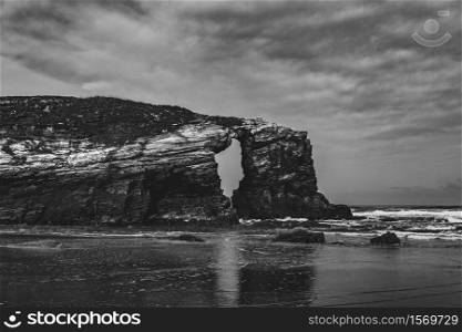 Black and white dramatic cliff in the spanish beach