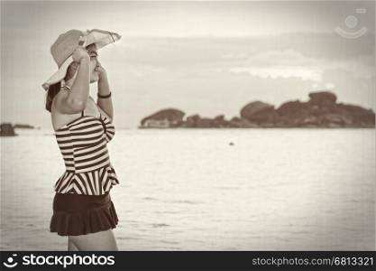 Black and white enhancer tone girl in a swimsuit and hat on the beach during sunrise vintage style at Koh Miang Islands, Mu Ko Similan National Park, Phang Nga, Thailand