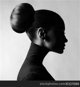 Black and white fashion art studio portrait of beautiful elegant woman in black turtleneck. Hair is collected in high beam. Elegant ballet style