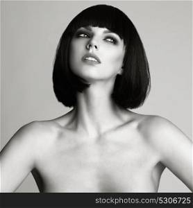 Black and white Fashion photo of beautiful elegant woman with short haircut. Brunette bob hairstyle. Makeup, Health and Beauty