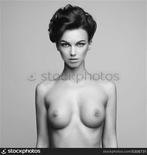 Black and white fashion photo of nude elegant woman with elegant hairstyle. Health and beauty
