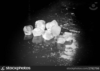 black and white ice cubes on an iced water surface