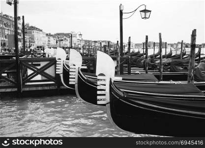 Black and white image of gondolas at the pier in San Marco Square. Black and white image of gondolas at the pier in San Marco Square, Venice, Italy