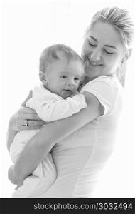 Black and white isolated portrait of young mother hugging her baby. Black and white isolated portrait of mother hugging her baby
