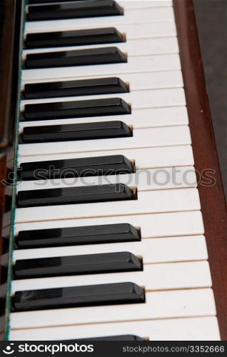 Black and white keys of old piano closeup