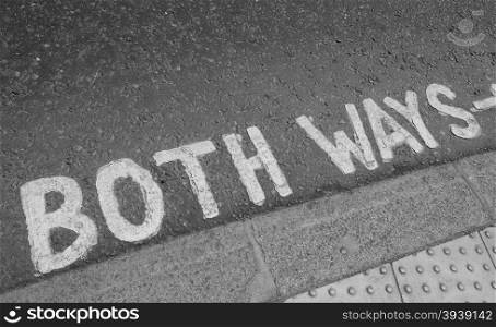 Black and white Look both ways sign. Look both ways sign in a London street in black and white