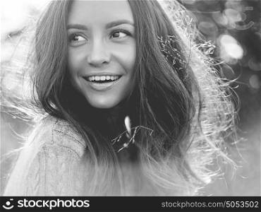 Black and white Outdoor atmospheric lifestyle photo of young beautiful lady. Brown hair and eyes. Warm autumn. Warm spring