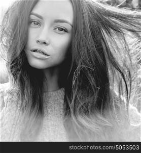 Black and white Outdoor atmospheric lifestyle photo of young beautiful lady. Brown hair and eyes. Warm autumn. Warm spring