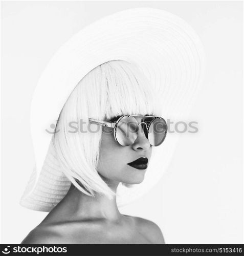 Black and white outdoor fashion photo of young beautiful lady in white hat and mirror sunglasses. Summer Beach travel. Summer vibes