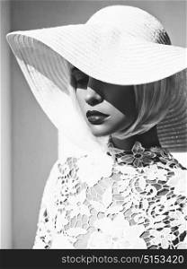 Black and white outdoor fashion photo of young beautiful lady in white hat. Summer Beach travel. Summer vibes