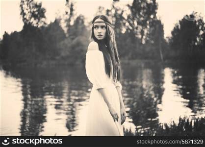 Black and white outdoors fashion photo of beautiful bohemian lady at river