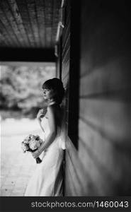 Black and white photo. elegant bride in white dress posing. Bride portrait wedding makeup and hairstyle, fashion bride. wedding day. noise and grain in the photo