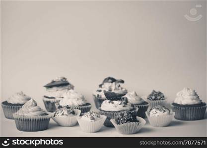 Black and white photo of assortment of sweets on background at studio