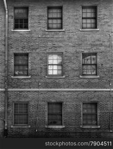 Black and white photo of brick facade with windows