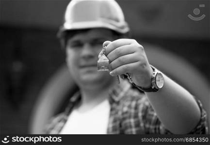 Black and white photo of building manager giving keys from new house