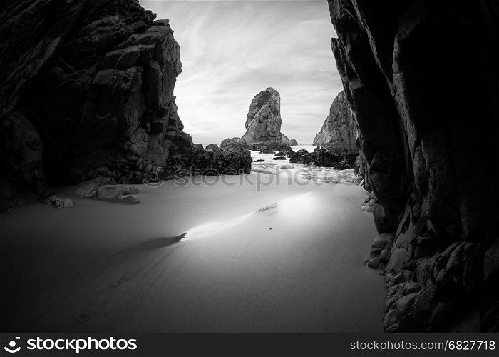 Black and white photo of rocky coastline of Atlantic ocean, Ursa beach, Portugal