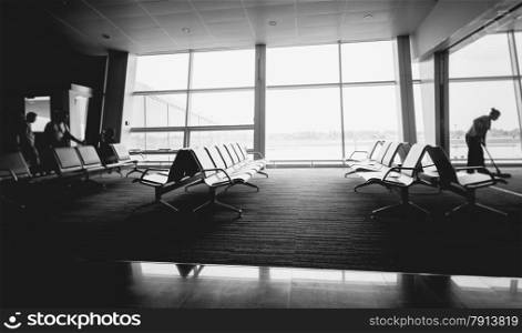 Black and white photo of rows of seats at airport terminal