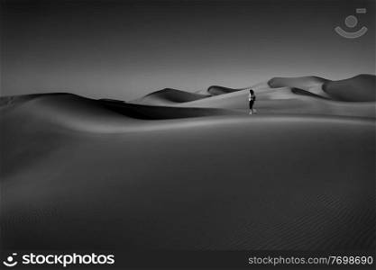 Black and White Photo of the Beautiful Desert, Through Which the Woman Walking So Freely. Enjoying the Magnificent Beauty of the Liwa Desert. Abu Dhabi. UAE.