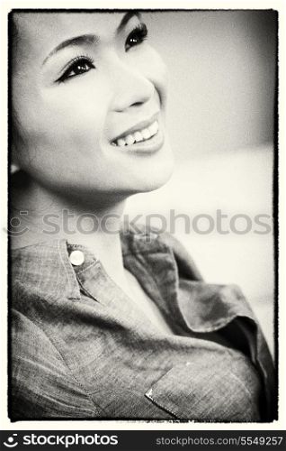 Black and white photograph of a beautiful young Chinese Asian woman with a wonderful toothy smile