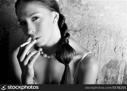 Black and white portrait of a sensual model smoking a sigarette
