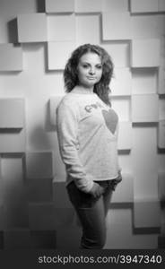 Black and white portrait of beautiful curly woman posing at studio