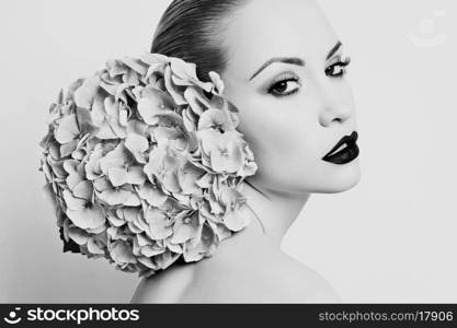 Black and white portrait of beautiful lady with hydrangea