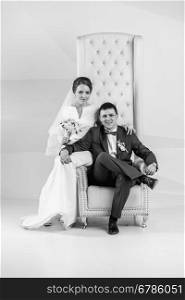 Black and white portrait of newly married couple posing at studio