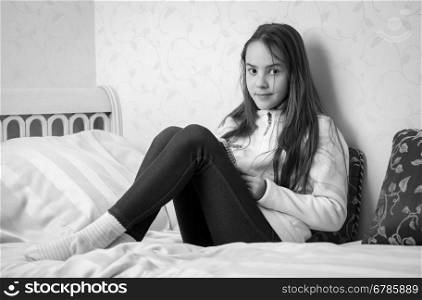 Black and white portrait of teenage girl making notes in diary