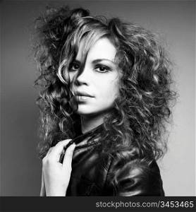 Black and white portrait of young beautiful curly girl