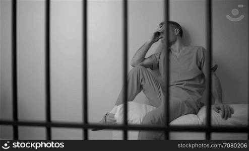 Black and white Sad inmate struggles in prison