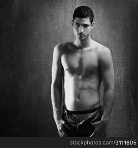Black and white sexy young denim shirtless man on retro grunge background