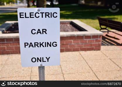 Black and white sign with reserved parking electric vehicles. Only text