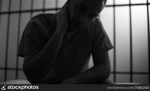 Black and white Silhouette of a very depressed inmate in prison