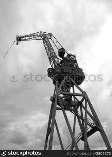 black and white silhouettes of cranes in the shipyard.