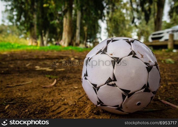 Black and white soccer ball on brown sand. Black and white soccer ball on brown sand.