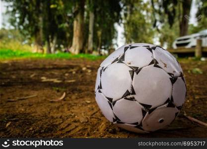 Black and white soccer ball on brown sand. Black and white soccer ball on brown sand.