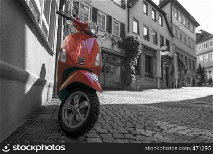 Black and white street photography with a red scooter on the emtpy strees of the german town Schwabisch Hall
