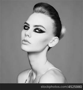 black and white studio photo of elegant lady with smoky eyes makeup.