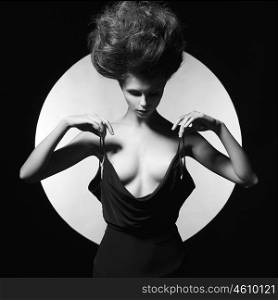 Black and white studio photo of elegant sensual woman on geometric background