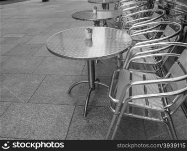 Black and white Tables and chairs. Tables and chairs of a dehors alfresco bar restaurant pub in black and white