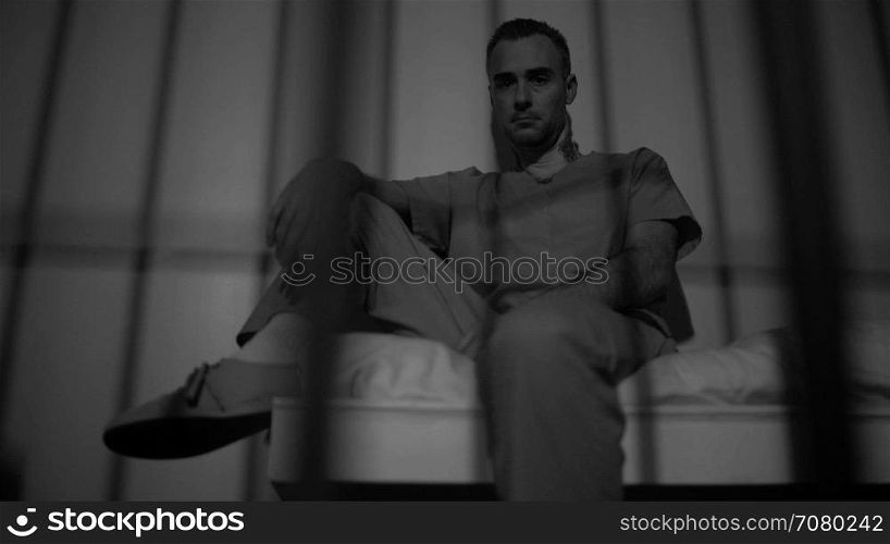 Black and white view of a hardened inmate contemplates life in prison