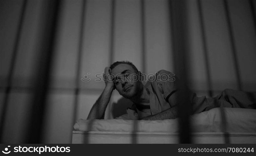 Black and white view of scene of a gloomy inmate in prison