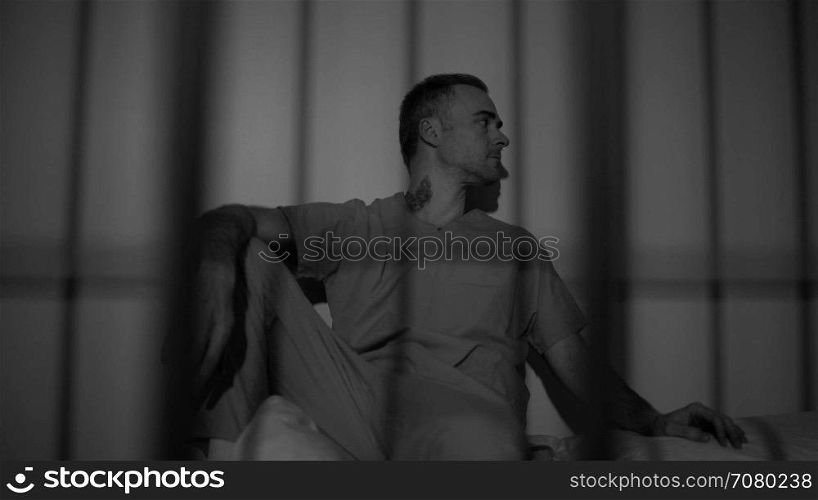 Black and white view of scene of a hardened criminal in jail