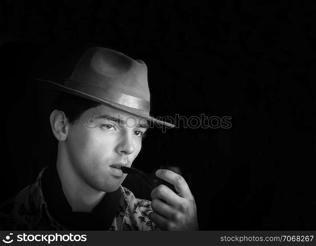 Black and white vintage portrait of a man in a hat smoking his pipe. Space for copy on a black background.. Black And White Vintage Portrait Of A Man With Pipe