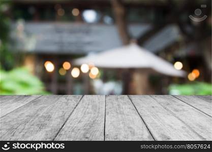 Black and white wooden table top with cafe blurred abstract background