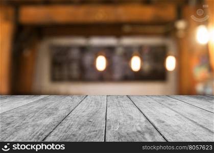 Black and white wooden table top with coffee shop blurred abstract background
