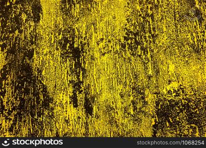 Black and yellow wall. Concrete wall painted into black and yellow. Black and yellow splashes on the wall.