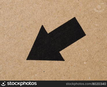 Black arrow on cardboard. Black arrow on brown corrugated cardboard, down left direction